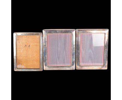 A George V silver-fronted oak photo frame, overall 21.5cm x 15.5cm, and a pair of silver plated photo frames (3)Lot sold as s