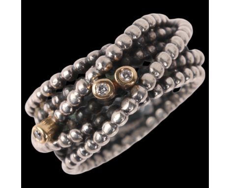 A Danish modernist sterling silver cubic zirconia beaded band ring, band width 9.8mm, size K, 8.1gNo damage or repair, only g
