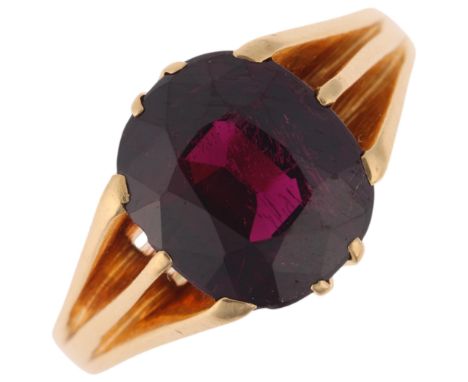 An Antique 18ct gold almandine garnet gypsy ring, maker IJR, London 1914, set with a 6ct oval-cut purple almandine garnet, se
