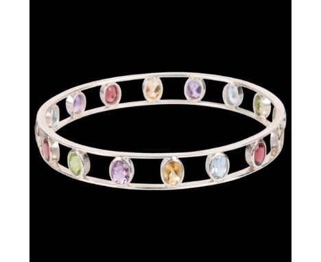 A sterling silver gem set openwork bangle, set with oval mixed-cut gemstones, gemstones include smoky quartz peridot blue top