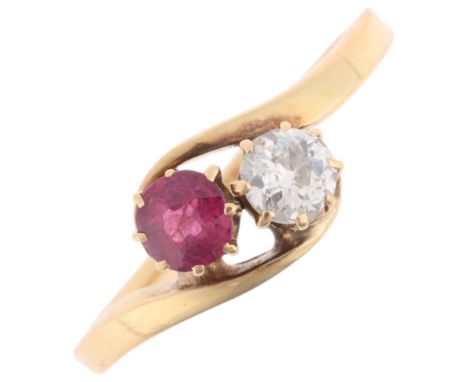 An Antique 18ct gold two stone ruby and diamond crossover ring, set with 0.25ct round-cut ruby and 0.2ct old European-cut dia