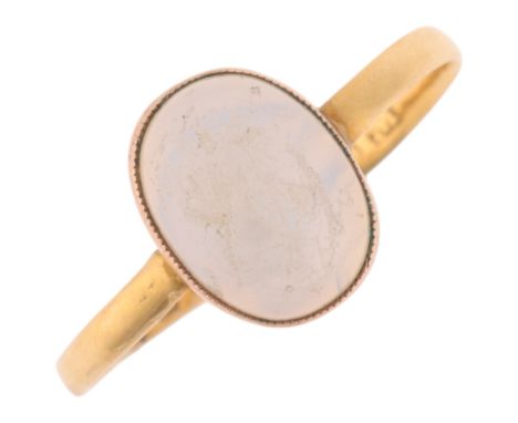 A 22ct gold opaline glass dress ring, maker WS, indistinct Birmingham date letter, rub-over set with oval cabochon glass, set