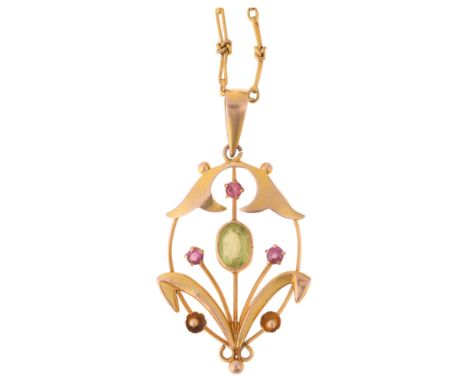 An Art Nouveau Edwardian 9ct gold peridot ruby openwork floral pendant necklace, in the Suffragette style, on gilt-metal knot