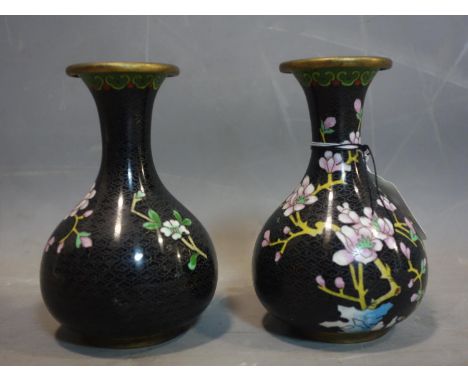 A pair of Chinese cloisonne enamel and brass vases, decorated with a bird by a cherry blossom tree on a black ground with sty