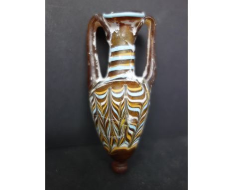Ancient Phoenician sand core-formed Amphoriskos, light brown glass wound with blue, yellow, and white marbled festoons, the r