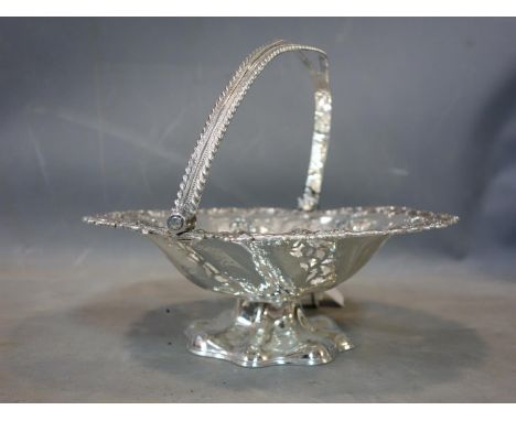 A 19th century silver swing handled fruit basket of pierced circular form decorated with grape vines to pierced edge, with pi