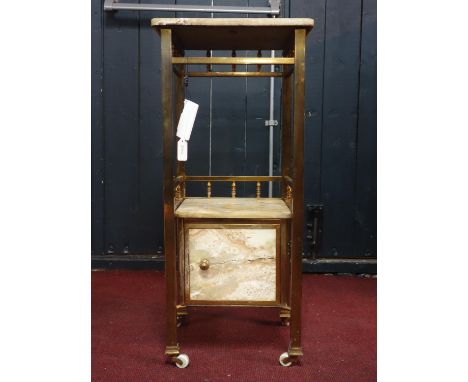 A brass and marble two tier lamp table, with two marble topped tiers above single cupboard door on square legs and castors, H