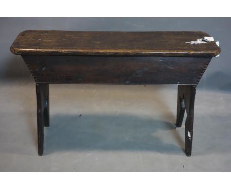 A late 19th century oak stool, on bracket supports, H.51 W.86 D.27cm 