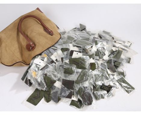 Large quantity of embroidered British military rank chevrons, black on green, with some 'U.S. Army' chest insignia and 'Ruptu