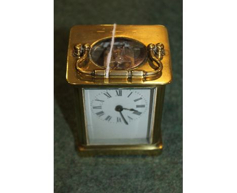 French brass cased carriage clock, the white enamel dial with Roman numerals, 14cm high to top of handle