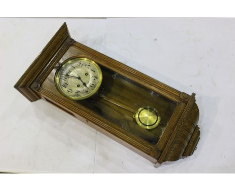 Oak cased Edwardian wall clock, the silvered dial with Arabic numerals, 33cm wide, 69cm high