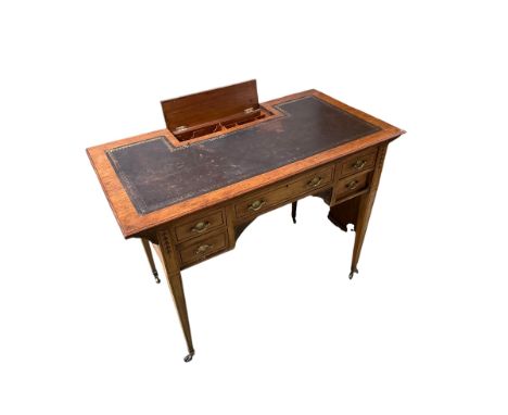 Two items: A small knee hole writing desk with 5 drawers and leather top, and inset stationery tidy to back, on slender taper