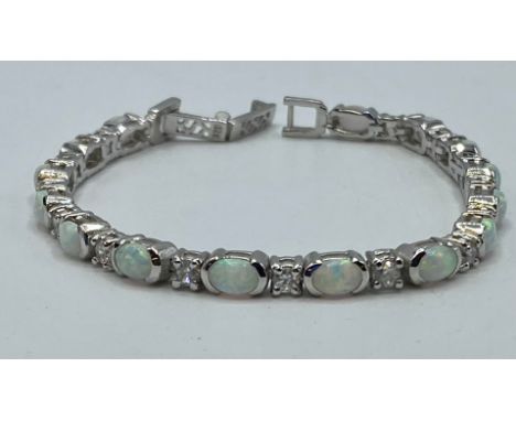 A Sterling silver 18cm. 14.4g silver and&nbsp;reconstituted&nbsp; opal line bracelet.