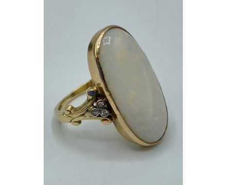 A 9 ct gold Opal and Diamond dress ring oval cabochon cut opal 25 mm x 14mm with single cut diamond shoulders, size N 5.6 g