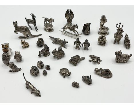 A collection of sterling silver miniature items. Mostly cast animals with with  a Lincoln imp , rocking horse bear pin cushio