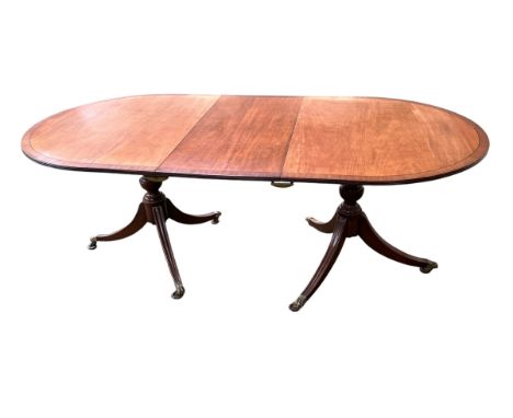 A twin pedestal light mahogany dining table, 195cm extended x 99cm Wide . Central removable leaf measures 44cm . 73cm H. some