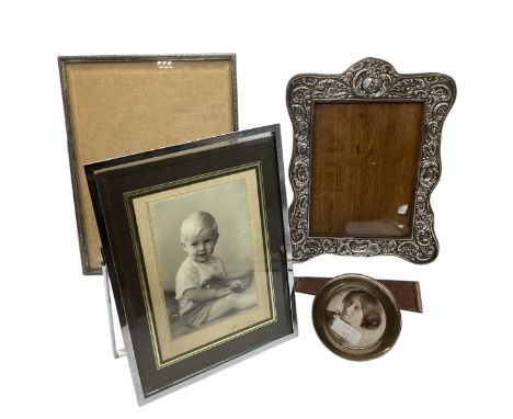 A sterling silver mounted  easel backed dressing table mirror 31cm x 24cm, together with three unmarked white metal examples.