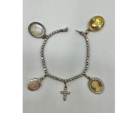 Cartier. An unmarked white metal and diamond line bracelet with four Cartier charms, A moonstone intaglio with surround of ro