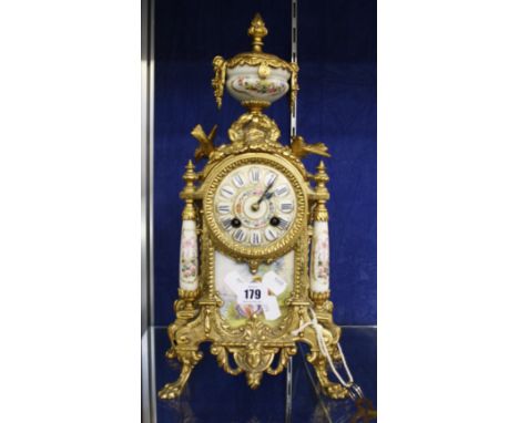 A French gilt metal mounted mantel clock with Sevres style plaques, 40cm high