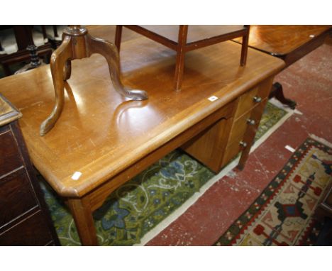 A mahogany desk with three short drawers, an oak two drawer side table 84cm and a nest of oak tables