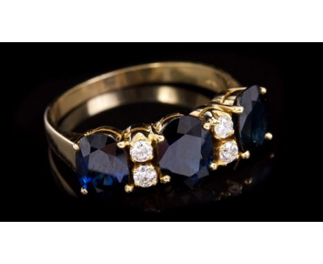 Sapphire and diamond ring with three oval mixed cut blue sapphires interspaced by four brilliant cut diamonds in gold (18ct) 