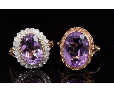 Amethyst and diamond cluster ring with an oval mixed cut amethyst, measuring approximately 14mm x 10mm, surrounded by twenty-