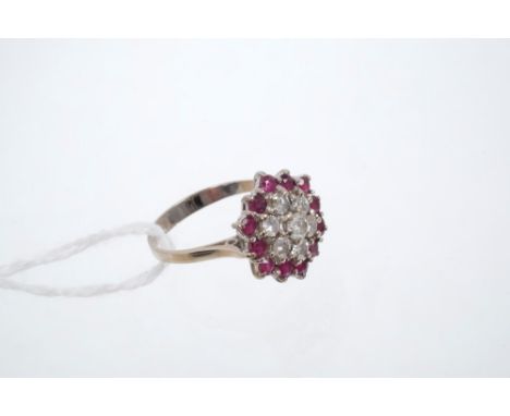 Ruby and diamond cluster ring, the hexagonal cluster centred with seven brilliant cut diamonds surrounded by a border of roun