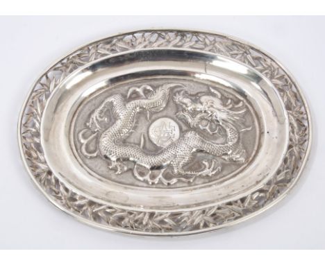 Late 19th / early 20th century Chinese silver pin tray of oval form, with embossed dragon decoration, engraved monogram and p