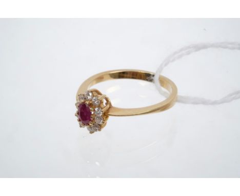Ruby and diamond cluster ring, the oval mixed cut ruby surrounded by ten brilliant cut diamonds, on plain shank, stamped - 75