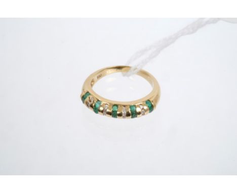 Gold (18ct) emerald and diamond ring, the band with alternating rows of emeralds and diamonds.  Ring size O