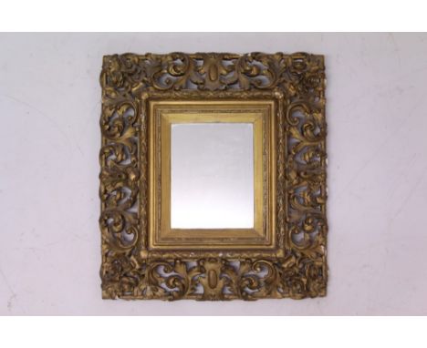 19th century Florentine carved gilt gesso wall mirror, rectangular mirrored plate in scrolling pierced foliate frame, 57cm x 