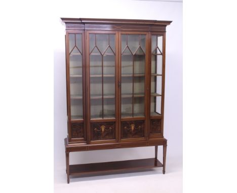 Edwardian mahogany and boxwood crossbanded breakfront display cabinet, the fabric-lined shelved interior enclosed by pair of 