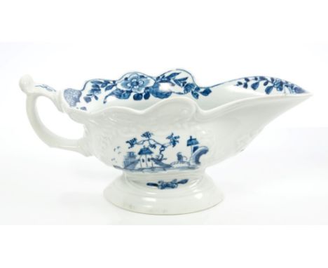 18th century Worcester high-footed oval sauce boat, the loop handle with scroll thumb piece, painted in underglaze blue with 