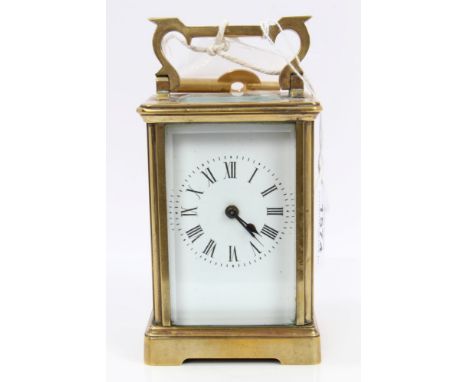 Early 20th century brass carriage clock with white enamel dial, brass case with bevelled glass panels, on bracket feet, 15cm 