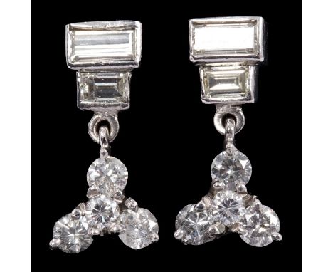 Pair Art Deco-style diamond drop earrings, each with two graduated baguette cut diamonds suspending a trefoil cluster of four