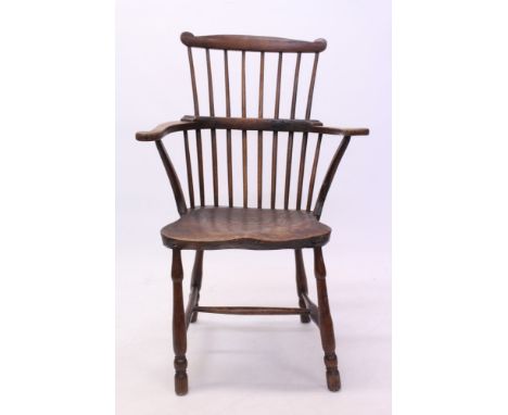 Good early 19th century beech and elm primitive comb back elbow chair with bowed stick back and well-figured saddle seat on t