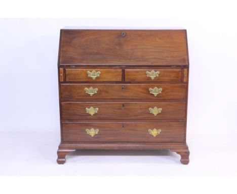 Good large George II mahogany bureau, the sloping fall enclosing a stepped interior of short drawers, slides and pigeon holes