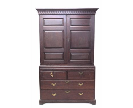 George III and later oak linen press with dentil cornice, the upper section of slides enclosed by fielded panel doors, above 