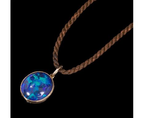 Edwardian black opal pendant, the oval cabochon measuring approximately 13mm x 11.5mm x 4.25mm, in millegrain gold setting, o