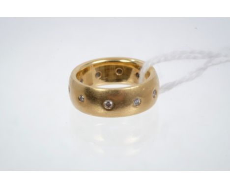 Yellow metal wedding band set with ten diamonds in rub-over setting, stamped - 18ct.  Ring size H CONDITION REPORT Weight:  a