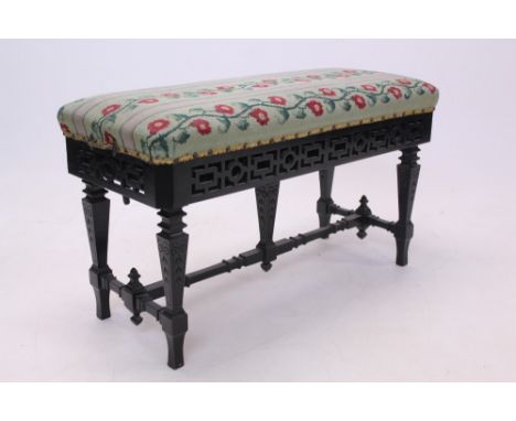 Unusual Victorian ebonised patent duet piano stool, by Chas. Wadman, Bath, with rectangular tapestry seat and geometric pierc