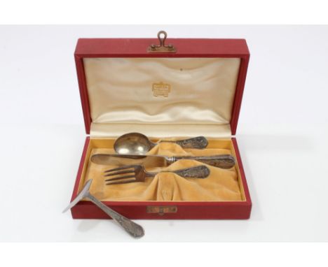 Cartier silver four piece christening set - comprising knife, fork, spoon and pusher, each with raised Nursery Rhyme motif, i