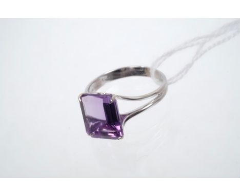 Amethyst single stone ring, the step cut amethyst weighing approximately 5.80 carats, in white gold (18ct) setting.  Ring siz