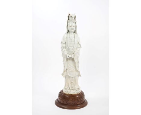 Large 17th century Chinese blanc-de-chine figure of Guanyin holding a scroll, on later carved wood base, 66cm high