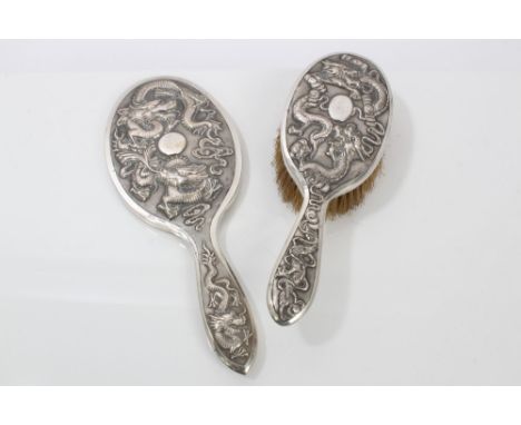Late 19th / early 20th century Chinese silver hand mirror with raised dragon decoration against a matted background and separ