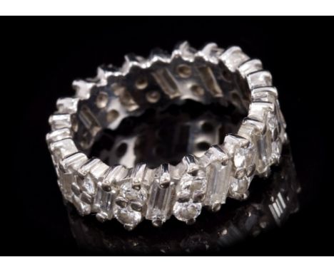 Diamond full band eternity ring with baguette cut diamonds alternating with duos of brilliant cut diamonds.  Estimated total 