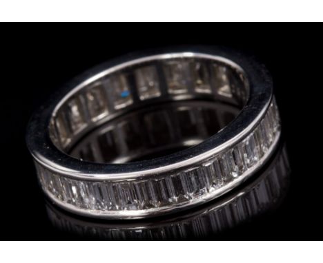 Diamond full band eternity ring, with a continuous band of channel set baguette cut diamonds in platinum (950 Standard) setti