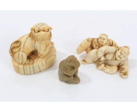 19th century Japanese carved ivory netsuke - carved as four jovial figures reclining on carpets, 5cm long, together with anot