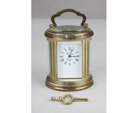 An brass and bevelled cased oval boudoir carriage clock by L'Epee,  the face with Roman numerals marked L'Epee Fondee en 1839