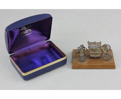 An Elizabeth II silver miniature coronation carriage, maker Toye, Kenning & Spencer, Birmingham, 1977, on wooden base, in ori